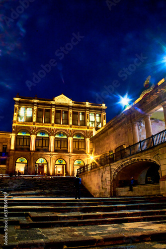 stairs in street of downtown center at night  buildings with golden lights in zacatecas  mexico 