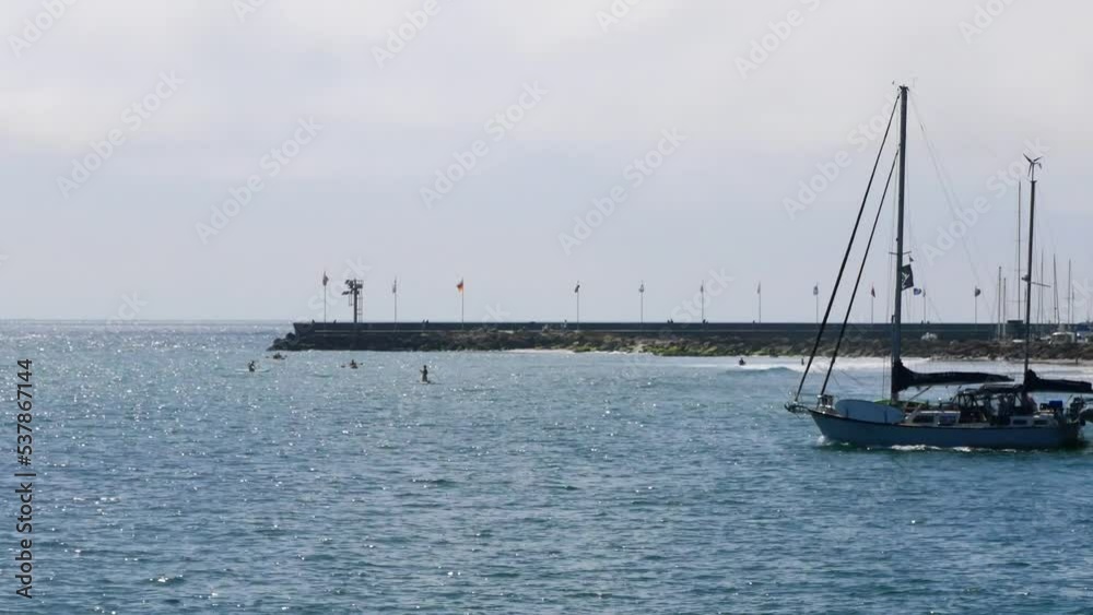Sailboat traveling right to left across the Pacific Ocean away from the coast of Santa Barbara, California. Sailboat traveling right to left across the Pacific Ocean away from the coast of Santa Barbara, California.