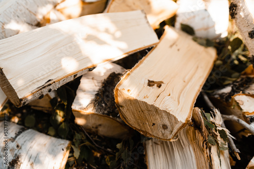 Stacks of firewood. Preparation of firewood for winter. Lots of firewood. Firewood background, selective focus