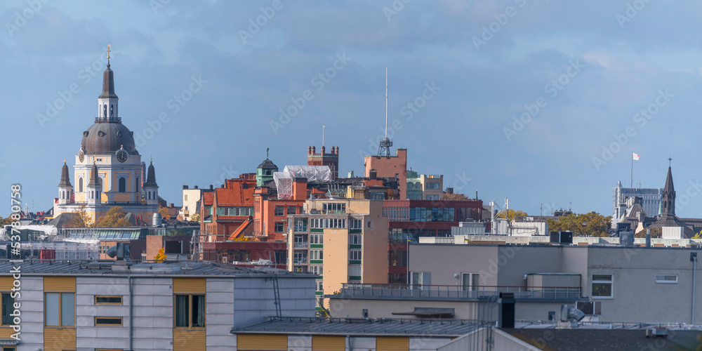 Facades and roofs of apartment houses and the church Katarina kyrka a sunny a color full autumn day in Stockholm