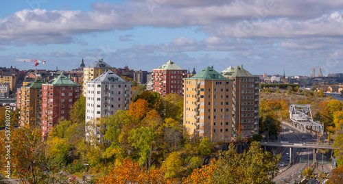 Skyscrapers on a hill at the Danviken passage to the Hammarby Strand a sunny a color full autumn day in Stockholm