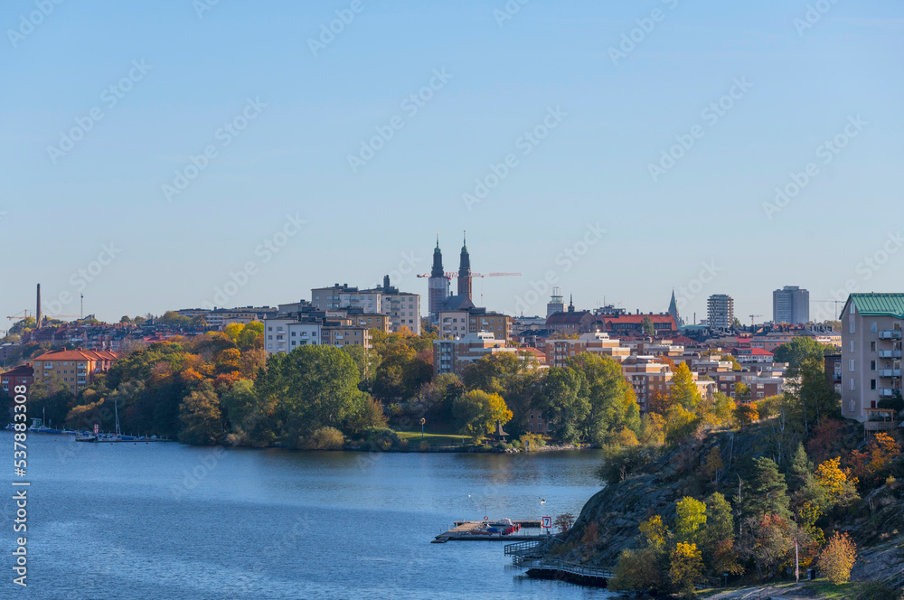 Apartment houses and church spires on the islands Reimers Holme and Södermalm a color full autumn day in Stockholm