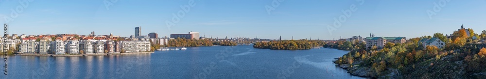 Essingen Lux district on island Lilla Essingen, bridge Västerbron,  district Södermalm, skyline with towers at a bay in the lake Mälaren a sunny a color full autumn day in Stockholm