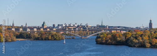 Panorama view over the long high bridge Västerbron between islands and the down town with skyscrapers and towers a color full autumn day in Stockholm