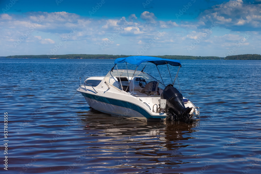 Motor boat on a wide river in summer Motor boat on a wide river in summer