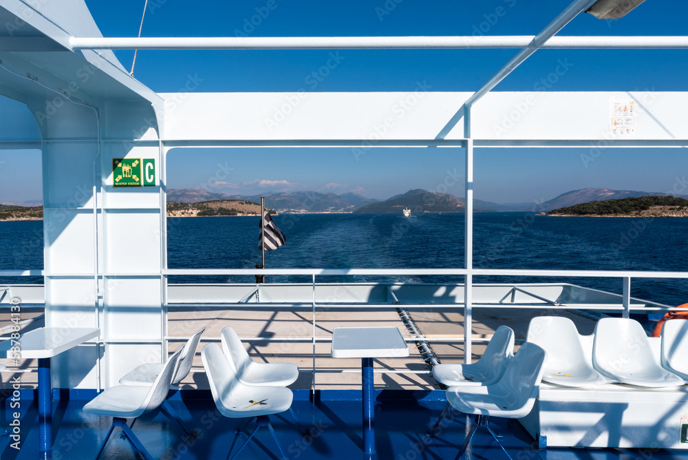 Fototapeta premium Ferry boat deck with empty seats and sea view. Mediterranean sea, Greece.