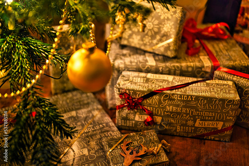 Christmas scene with decorations and presents under a fir tree. The focus lies in the foreground.