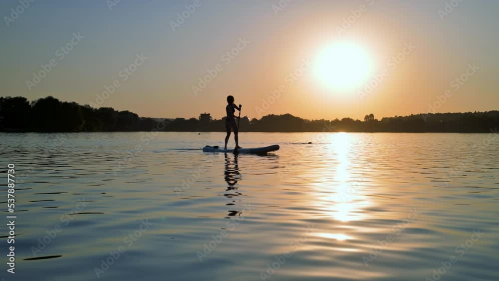 Woman using sup board on a river. 4k video footage UHD 3840x2160 Woman using sup board on a river. 4k video footage UHD 3840x2160