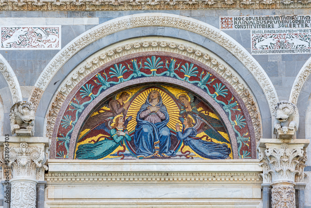 Detail of colorful mosaic decorating arch interior on the exterior facade of catholic basilica in Pisa
