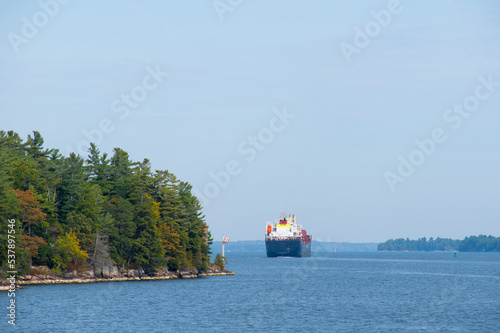 Obraz na płótnie Large cargo ship plying through the St Lawrence River in fall