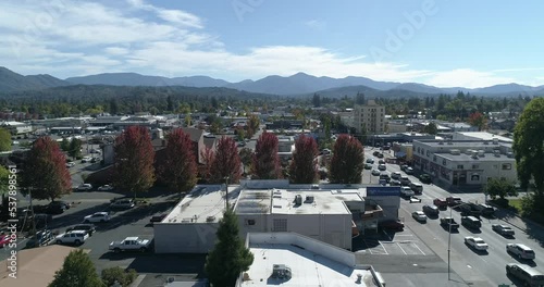 Aerial view of downtown car traffic in Grants Pass, Oregon. Rotating drone shot.