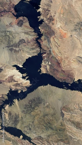 Lake drying time lapse global warming water resource reservoir drought, vertical video aerial view from satellite time lapse animation, lake Mead United States. Based on images by Nasa