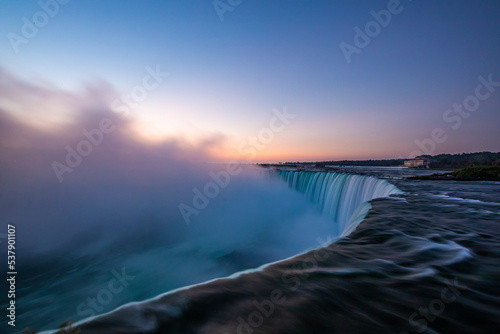 Sunrise over Horseshoe Falls closeup in the morning with mist at Niagara Falls in Canada, slow shutter speed, long exposure