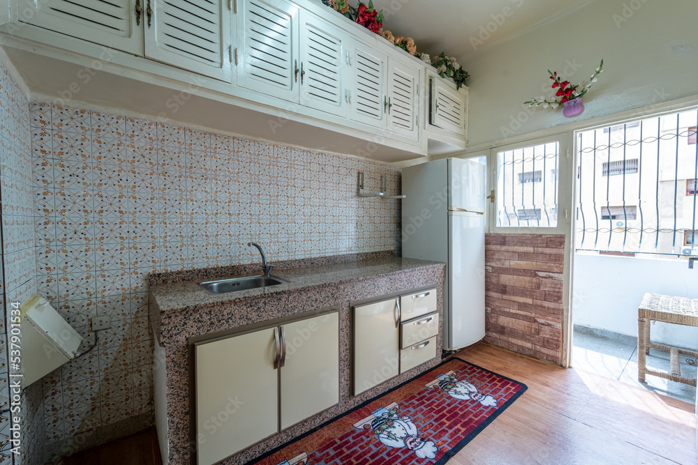 Image showcasing The interior of a kitchen with natural light Stock Photo | Adobe Stock