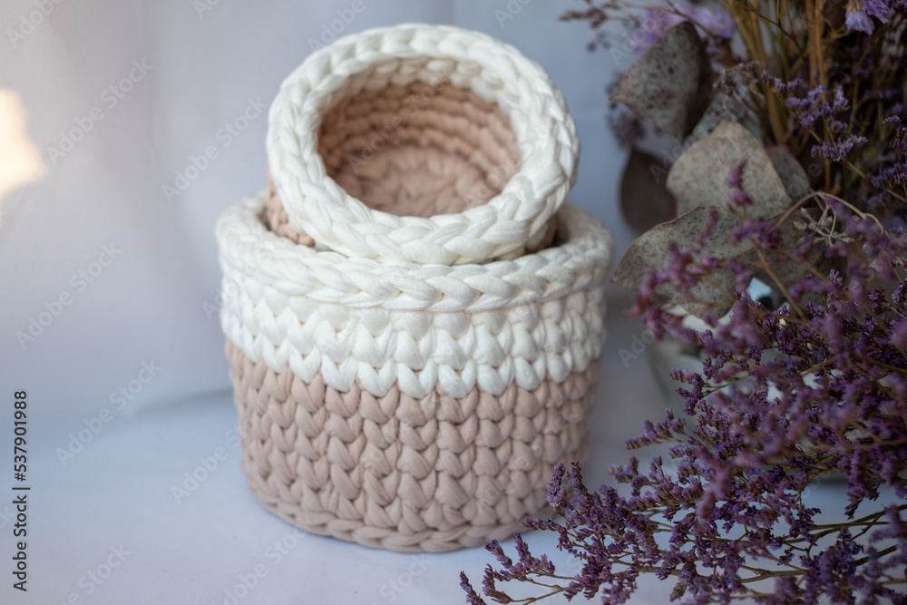 Purple cute decorative hand crocheted baskets, sustainable handicraft business, cozy home atmosphere with decorative purple dry  plants and white background
