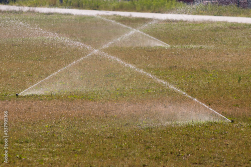 Automatic watering of the lawn during the heat. Watering the stadium. 