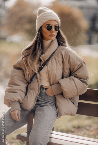 Stylish fashion pretty woman posing in the park. Urban style. Portrait of beautiful woman.