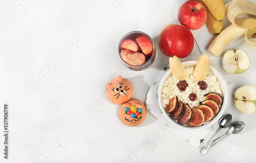 Healthy breakfast with ingredients, fun food for kids. Cottage cheese with figs and bananas, apples and grapes, top view, Healthy and natural food concept