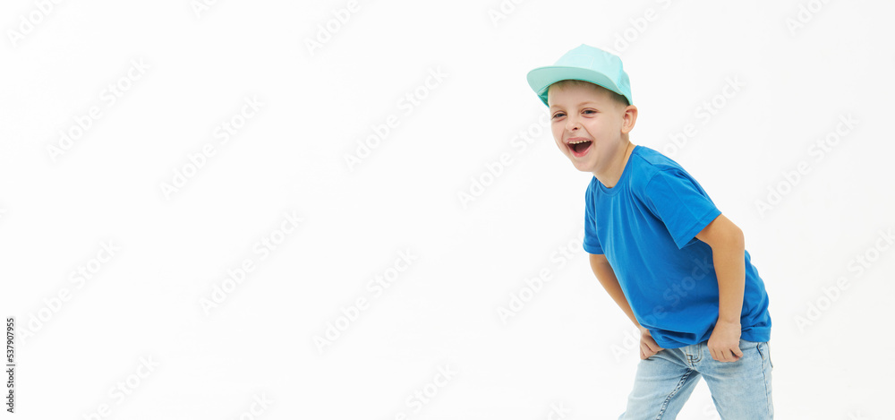 Stylish child boy laughing merrily with wide open mouth in a blue casual t-shirt and cap on a white isolated background Stylish child boy laughing merrily with wide open mouth in a blue casual t-shirt and cap on a white isolated background