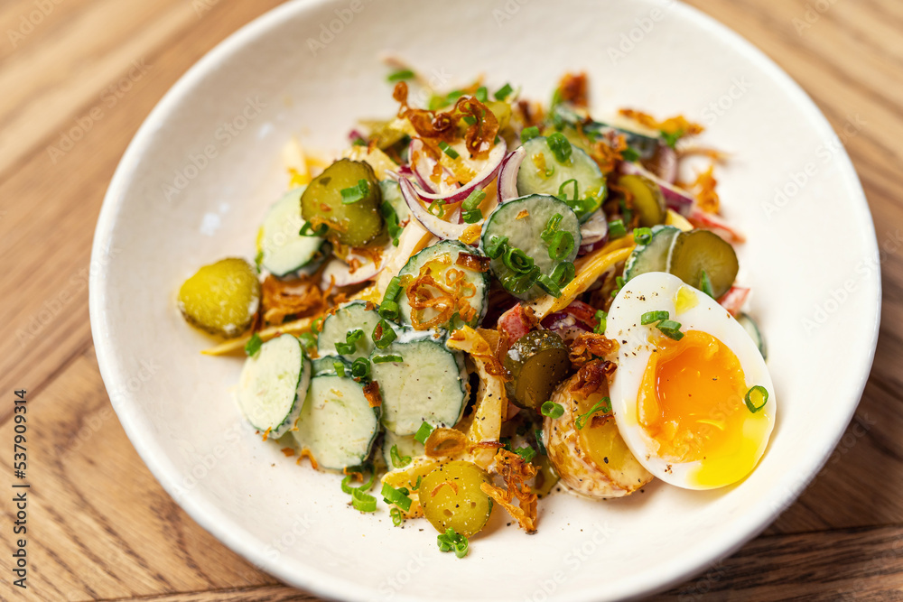 summer salad with radish in a restaurant on a colored plate summer salad with radish in a restaurant on a colored plate