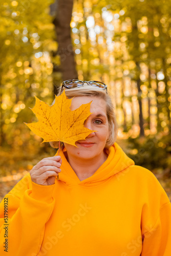 senior aged woman with maple leaf