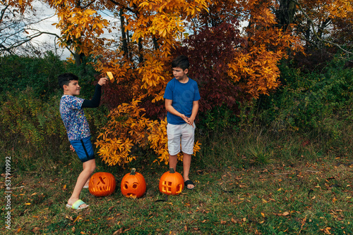 Younger brother being silly while older brother makes a face. 