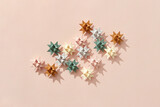 Paper craft stars scattered on beige background.