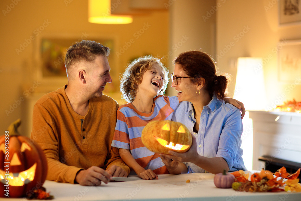 Family carving pumpkin. Halloween trick or treat