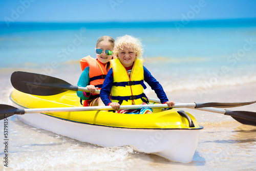 Kids kayaking in ocean. Children in kayak in tropical sea © famveldman