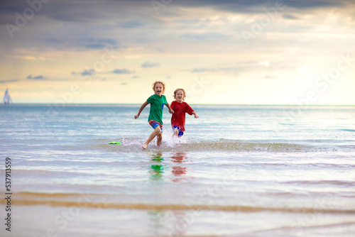 Kids play on tropical beach. Sand and water toy.