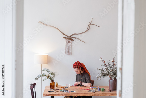 Female artisan working in light home studio