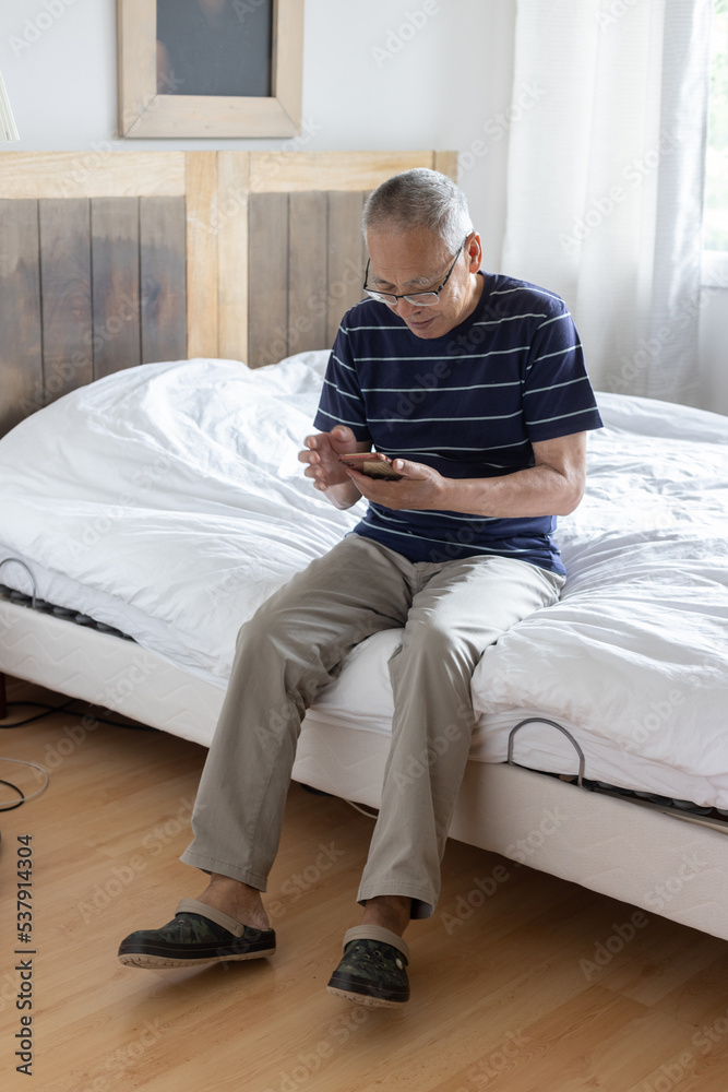 retired old man using smartphone at home retired old man using smartphone at home