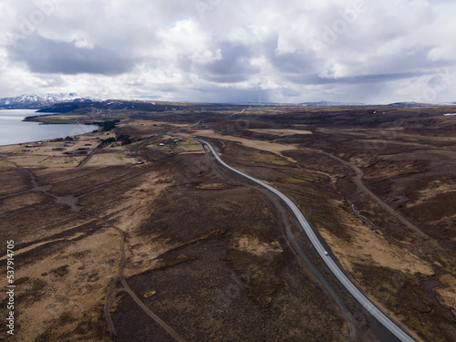 Nice aerial landscape road and field with moss clouds and mountain