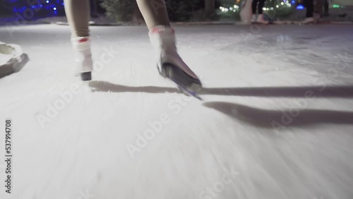 close-up of a girl's legs on ice skate