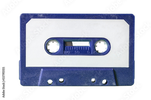 An old vintage cassette tape from the 1980s (obsolete music technology). Deep blue plastic body, white paper label. Isolated.
