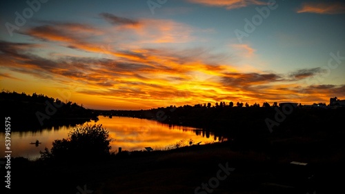 Mesmerizing view of a sunset with a cloudy sky over the Missouri river photo