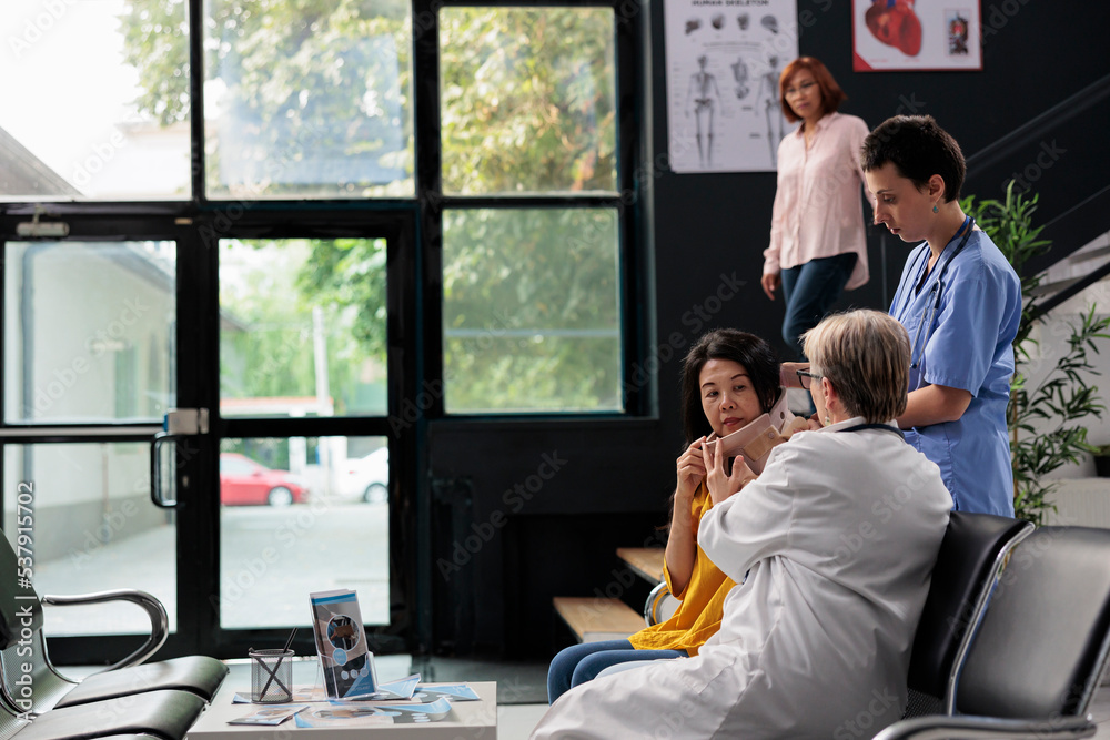 Fototapeta premium Medical assistant and medic helping senior woman with cervical neck collar, giving support to remove foam brace and recover. Specialists helping injured patient with fracture, medicine support