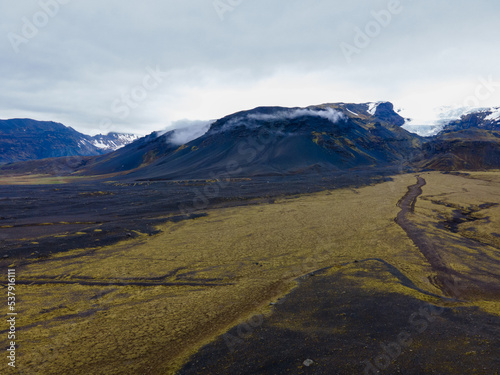 Aerial shot, Nice landscape of mountains and rivers with mossy field in iceland © Marian