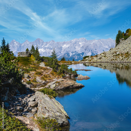 Calm autumn Alps mountain lake with clear transparent water and reflections. Spiegelsee or Mittersee or Mirror Lake, Reiteralm, Steiermark, Austria.