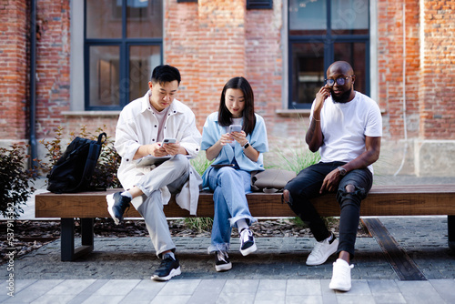 People sitting on pew and using gadgets 