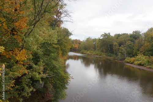 Curve in Perkiomen Creek in Fall with Trees of Green and Gold on Overcast Day