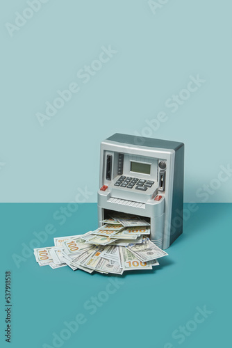 Withdrawing dollars from cash machine mock-up.