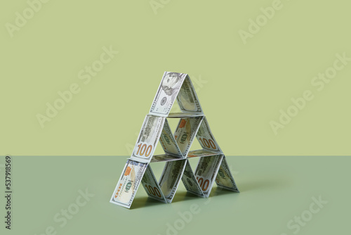 Dollar banknotes folded and laid in pyramid form. photo