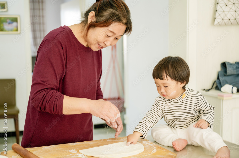 Cute baby girl cooking with grandma Cute baby girl cooking with grandma
