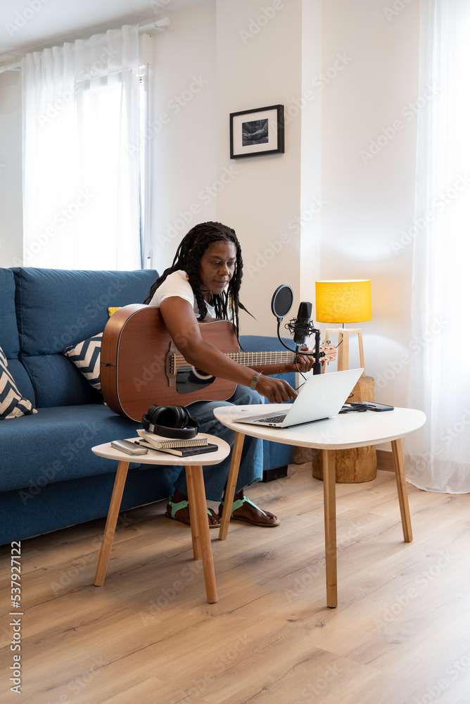 Old black lady Playing Guitar At Home 