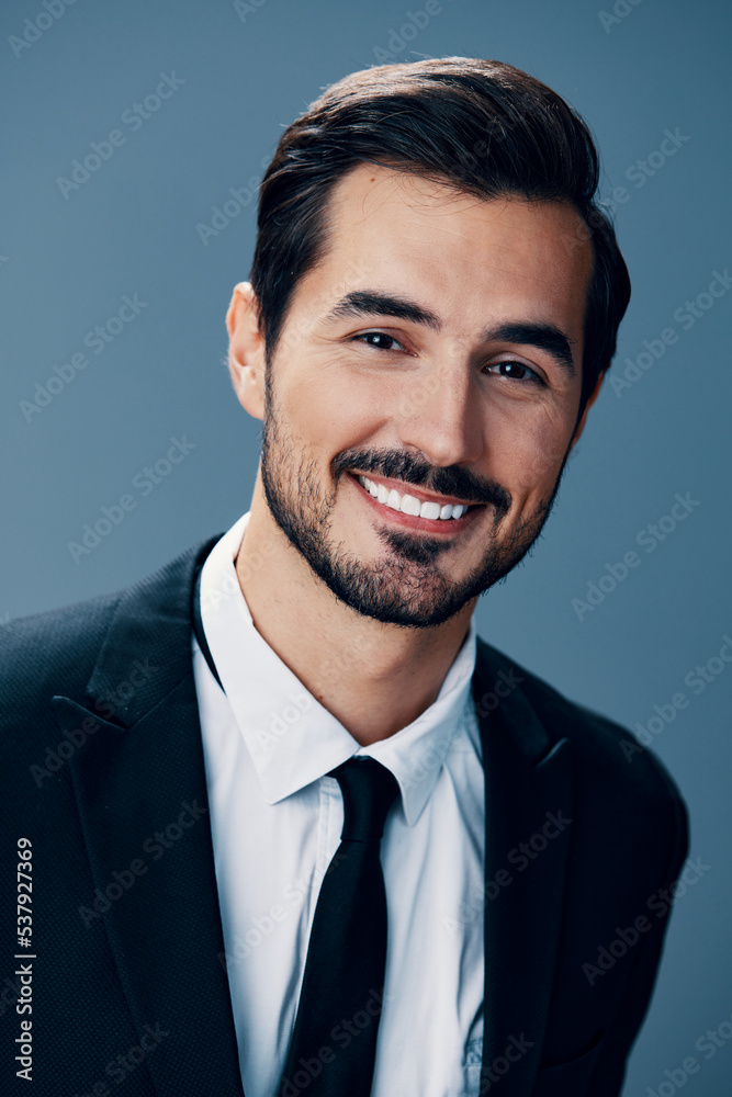 Portrait of a business man with a natural smile with teeth on a blue background in a business suit. Business portrait of a stylish man copy space Portrait of a business man with a natural smile with teeth on a blue background in a business suit. Business portrait of a stylish man copy space