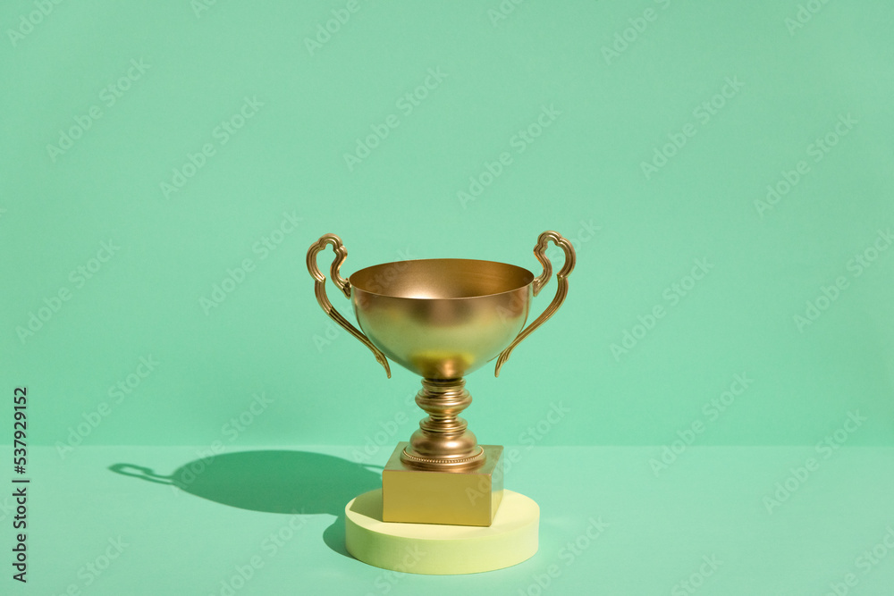 First place golden cup. Success and achievement, victory concept. First place golden cup. Success and achievement, victory concept.