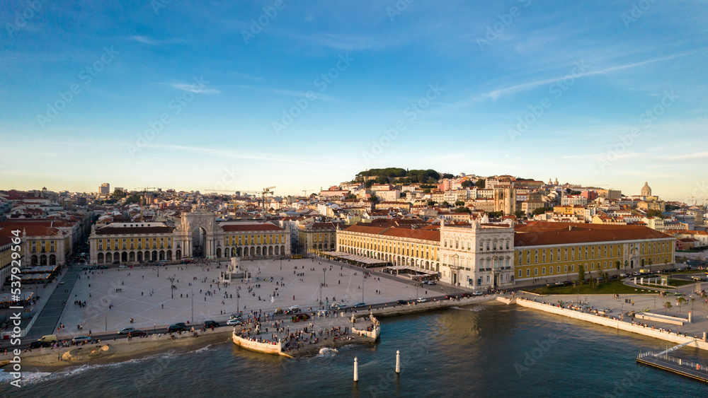 Aerial view of pedestrians at Praca do Comercio in Lisbon, Portugal with St. George Castle in the background as well as other Lisbon landmarks