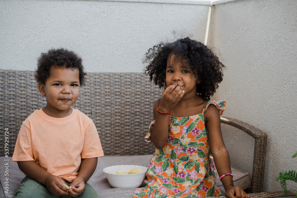Toddlers eating chips Stock Photo Adobe Stock