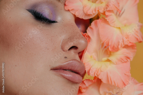 Closeup beauty portrait with closed eyes abd peachy flowers photo